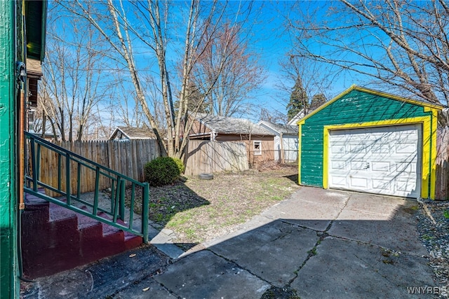 43 Freund St, Buffalo, NY 14211 - view of yard featuring a garage, an outdoor structure, fence, and concrete driveway