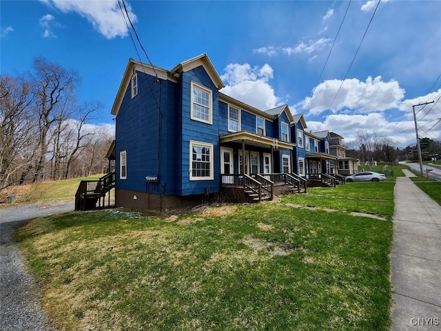 view of side of home with a yard