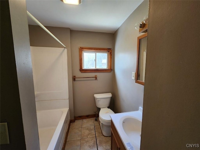 bathroom featuring tile patterned floors, toilet, vanity, and washtub / shower combination