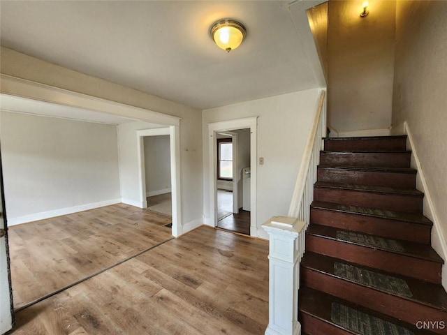 stairs with baseboards and wood finished floors
