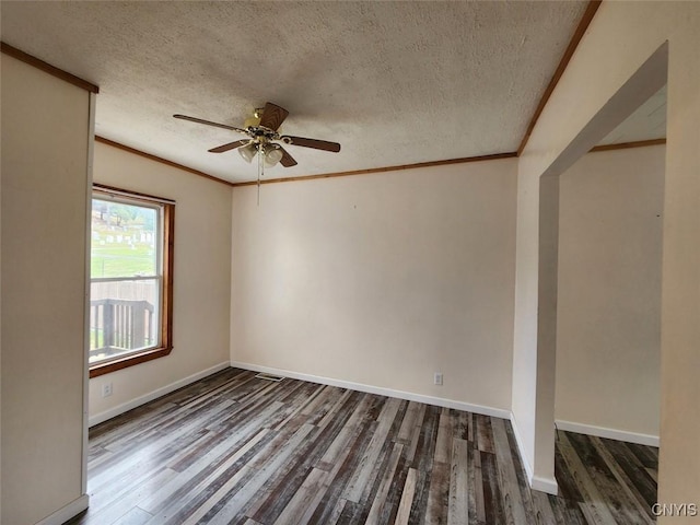 spare room featuring ornamental molding, a ceiling fan, and wood finished floors