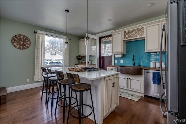 11853 State Route 12e, Lyme, NY 13622 - kitchen with a sink, decorative backsplash, appliances with stainless steel finishes, and dark wood-style flooring