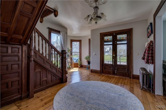 11853 State Route 12e, Lyme, NY 13622 - entrance foyer with stairs, light wood finished floors, and a notable chandelier