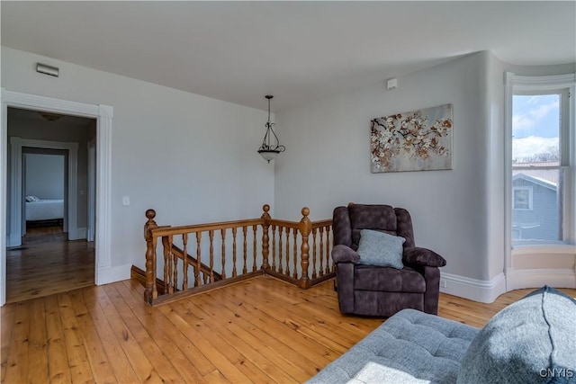 11853 State Route 12e, Lyme, NY 13622 - living area featuring light wood-style flooring, baseboards, and an upstairs landing