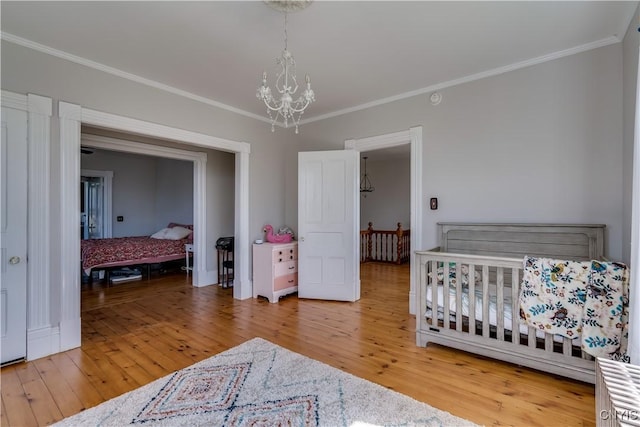 11853 State Route 12e, Lyme, NY 13622 - bedroom featuring crown molding, a notable chandelier, and hardwood / wood-style flooring