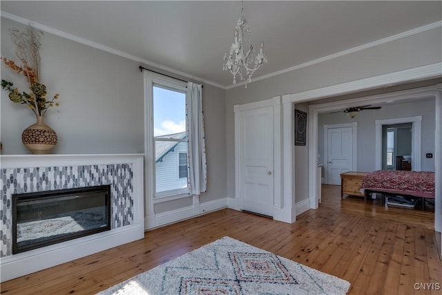 11853 State Route 12e, Lyme, NY 13622 - living room with crown molding, wood-type flooring, and a notable chandelier