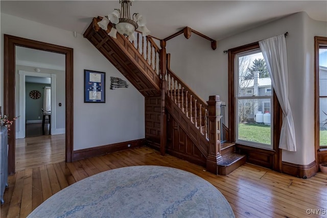 11853 State Route 12e, Lyme, NY 13622 - interior space with baseboards, hardwood / wood-style floors, and a notable chandelier