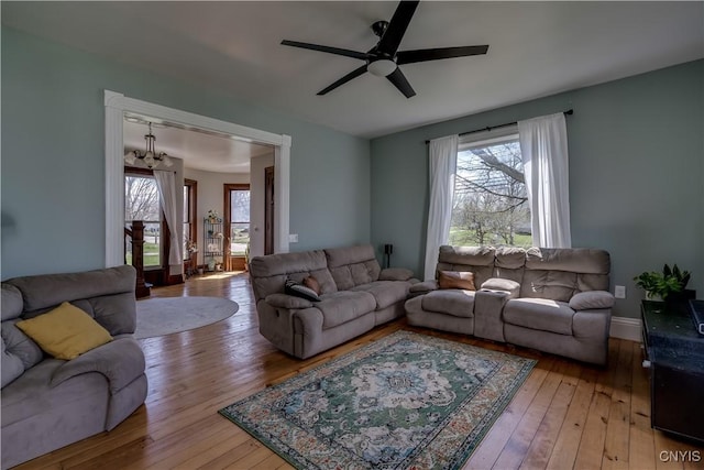 11853 State Route 12e, Lyme, NY 13622 - living room featuring a ceiling fan, hardwood / wood-style floors, and a healthy amount of sunlight