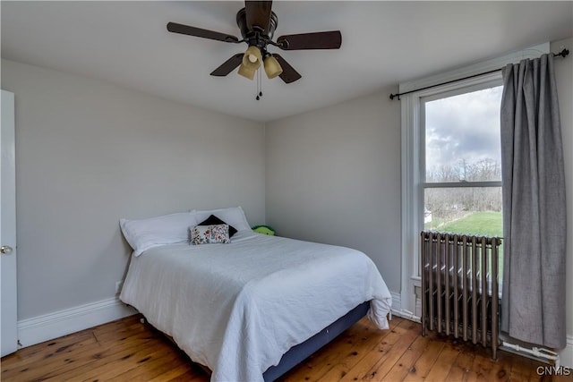 11853 State Route 12e, Lyme, NY 13622 - bedroom with ceiling fan, hardwood / wood-style floors, radiator heating unit, and baseboards