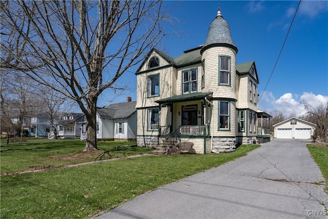 11853 State Route 12e, Lyme, NY 13622 - victorian house with a front yard, an outdoor structure, and a detached garage