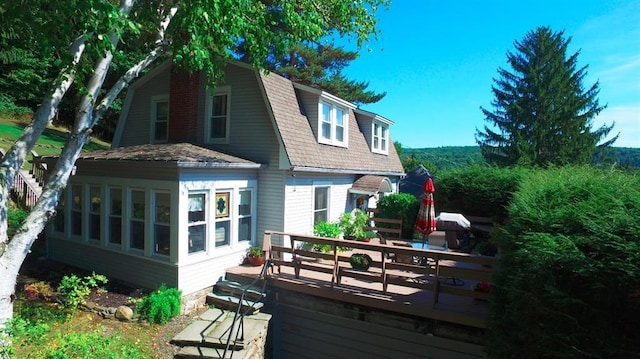 11 Cedar St, Oneonta-City, NY 13820 - rear view of house with a deck, a gambrel roof, and a sunroom