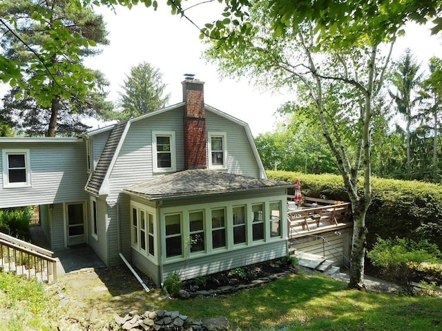 11 Cedar St, Oneonta-City, NY 13820 - back of house with a gambrel roof, a shingled roof, a deck, and a chimney