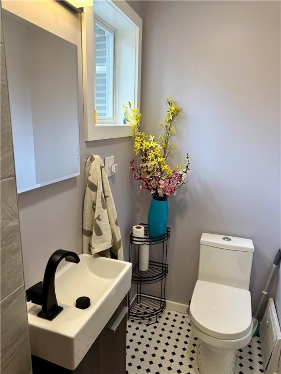 11 Cedar St, Oneonta-City, NY 13820 - bathroom with toilet, a sink, and baseboards