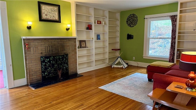 11 Cedar St, Oneonta-City, NY 13820 - living room featuring a fireplace, baseboards, and wood finished floors