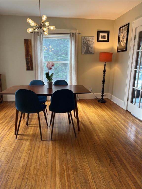 11 Cedar St, Oneonta-City, NY 13820 - dining space with a notable chandelier, baseboards, and wood finished floors
