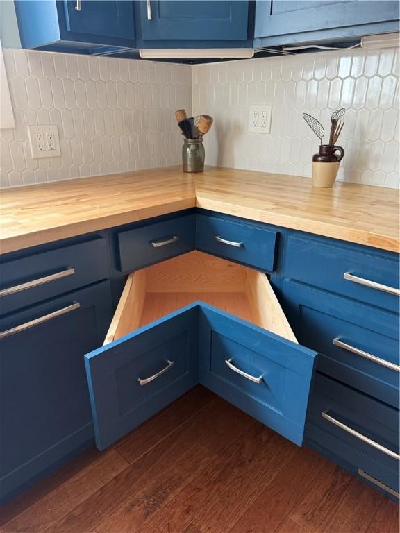 11 Cedar St, Oneonta-City, NY 13820 - interior details featuring dark wood-style flooring, butcher block countertops, backsplash, and blue cabinets