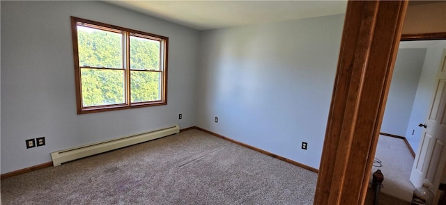 carpeted spare room with a baseboard radiator and baseboards