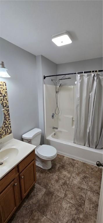 bathroom featuring shower / tub combo with curtain, vanity, toilet, and tile patterned flooring