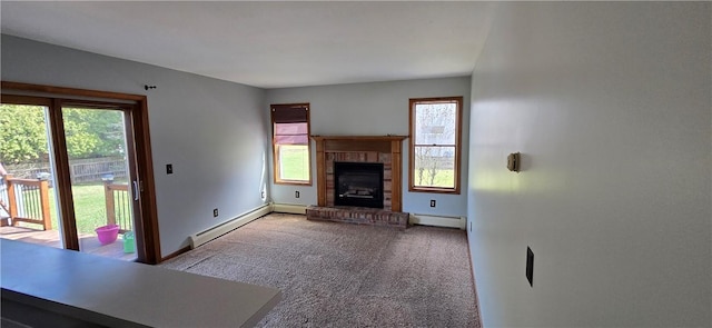 unfurnished living room featuring baseboards, carpet, a fireplace, baseboard heating, and a baseboard heating unit