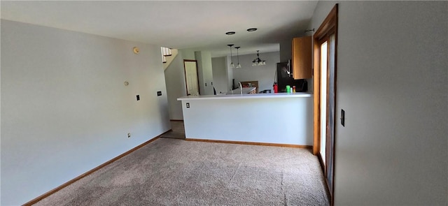 unfurnished living room featuring baseboards and carpet floors