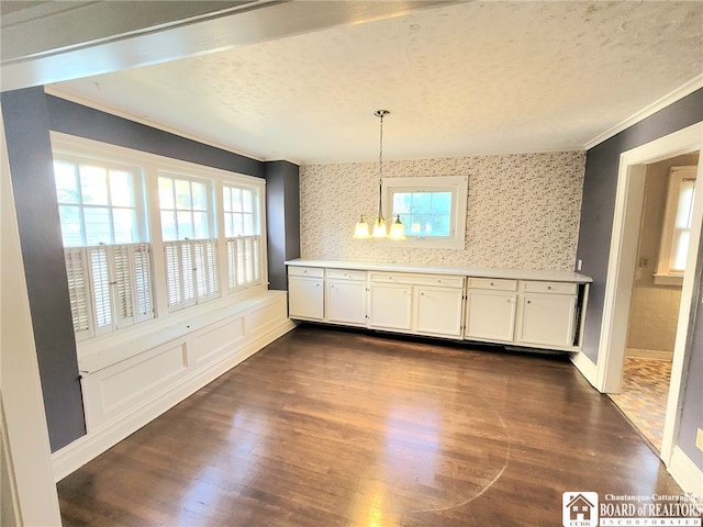 85 Dearborn St, Jamestown, NY 14701 - unfurnished dining area with an inviting chandelier, wallpapered walls, ornamental molding, and dark wood finished floors