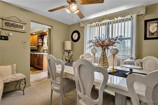 4757 N Bailey Ave, Amherst, NY 14226 - dining room with light colored carpet and a ceiling fan