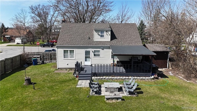 4757 N Bailey Ave, Amherst, NY 14226 - rear view of property featuring roof with shingles, fence, a patio area, a sunroom, and a lawn