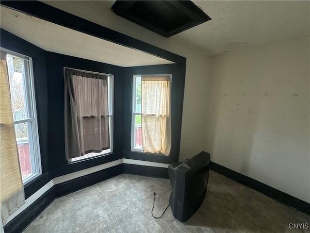 spare room with baseboards