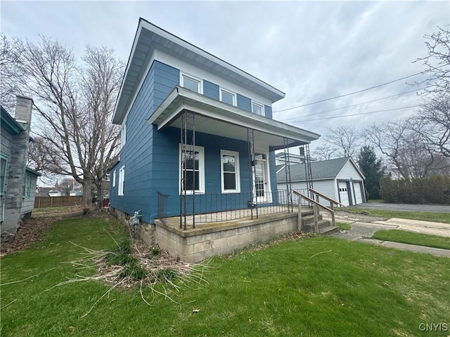 view of front of house featuring a front lawn, an outbuilding, a garage, fence, and covered porch