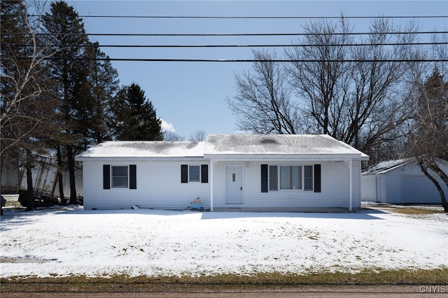 single story home with an outdoor structure and a detached garage