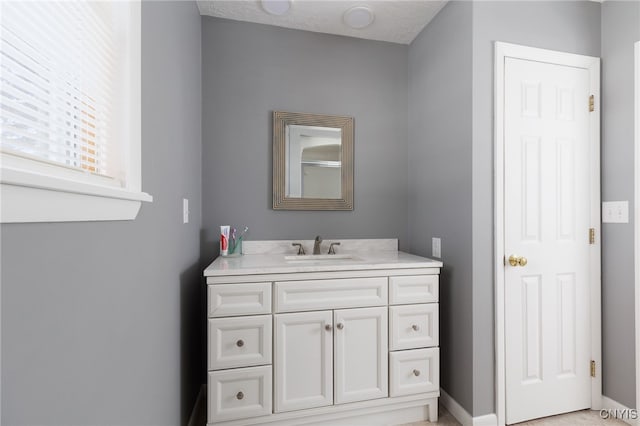 bathroom featuring vanity and baseboards
