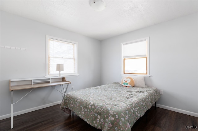 bedroom featuring wood finished floors and baseboards