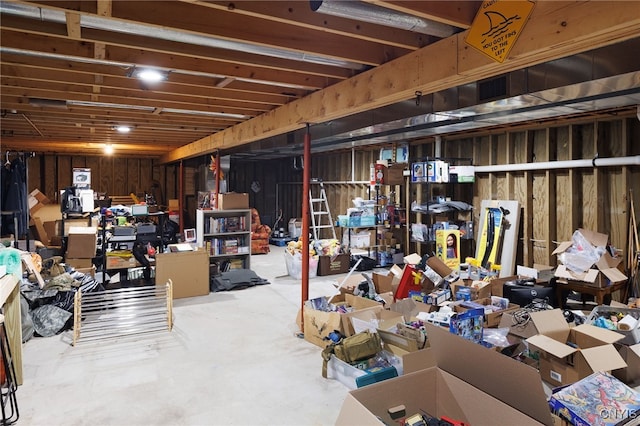 unfinished basement featuring wood walls