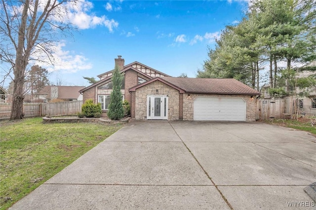 view of front of home with a garage, a chimney, fence, concrete driveway, and french doors