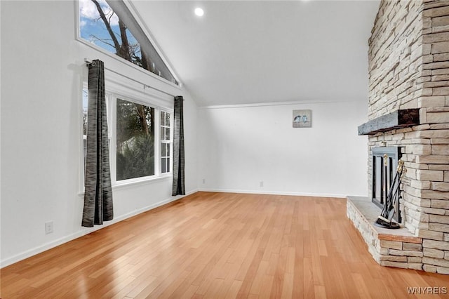 unfurnished living room featuring light wood-style flooring, high vaulted ceiling, a fireplace, and baseboards