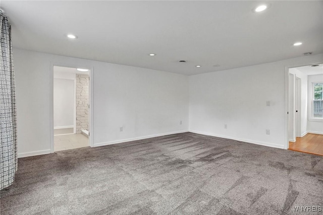 carpeted spare room featuring recessed lighting and baseboards