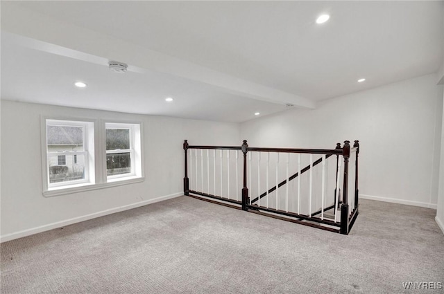 carpeted spare room featuring beamed ceiling, baseboards, and recessed lighting