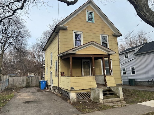 view of front of house featuring a porch and fence