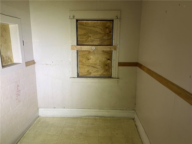 unfurnished room with tile patterned floors