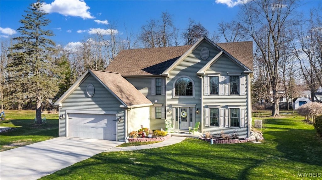 view of front facade with a front yard, a garage, and driveway