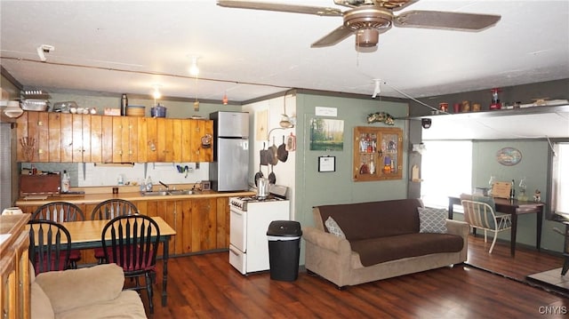 50 Apache Springs Rd, Boylston, NY 13083 - kitchen with white gas range oven, a sink, wood finished floors, a ceiling fan, and open floor plan