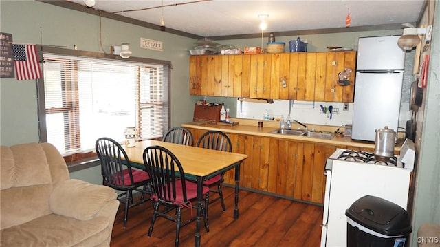 50 Apache Springs Rd, Boylston, NY 13083 - kitchen featuring white appliances, dark wood-style floors, brown cabinetry, a sink, and light countertops