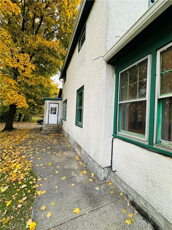 view of home's exterior with a patio, entry steps, and stucco siding