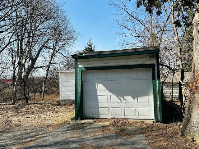 detached garage featuring driveway