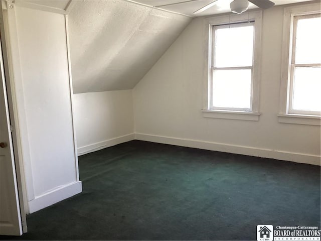 51 Leming St, Dunkirk-City, NY 14048 - bonus room with baseboards, a textured ceiling, a ceiling fan, dark carpet, and lofted ceiling