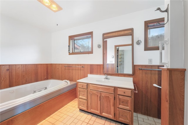 full bathroom with a bath, wood walls, wainscoting, and vanity