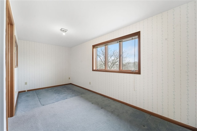 carpeted empty room with wallpapered walls, baseboards, and visible vents