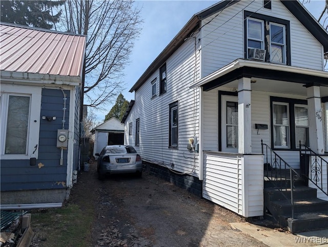 505 Canary St, Dunkirk-City, NY 14048 - view of property exterior featuring an outdoor structure, a garage, and covered porch