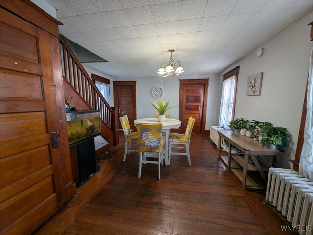 505 Canary St, Dunkirk-City, NY 14048 - dining room featuring dark wood finished floors, radiator, an inviting chandelier, and stairs