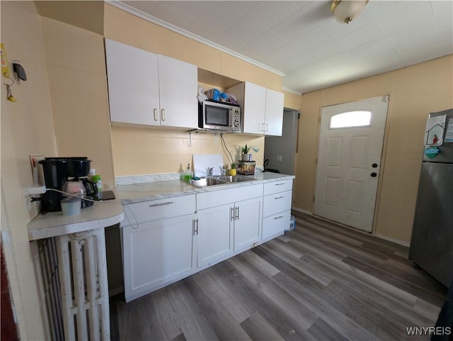 505 Canary St, Dunkirk-City, NY 14048 - kitchen with freestanding refrigerator, white cabinets, stainless steel microwave, light countertops, and a sink